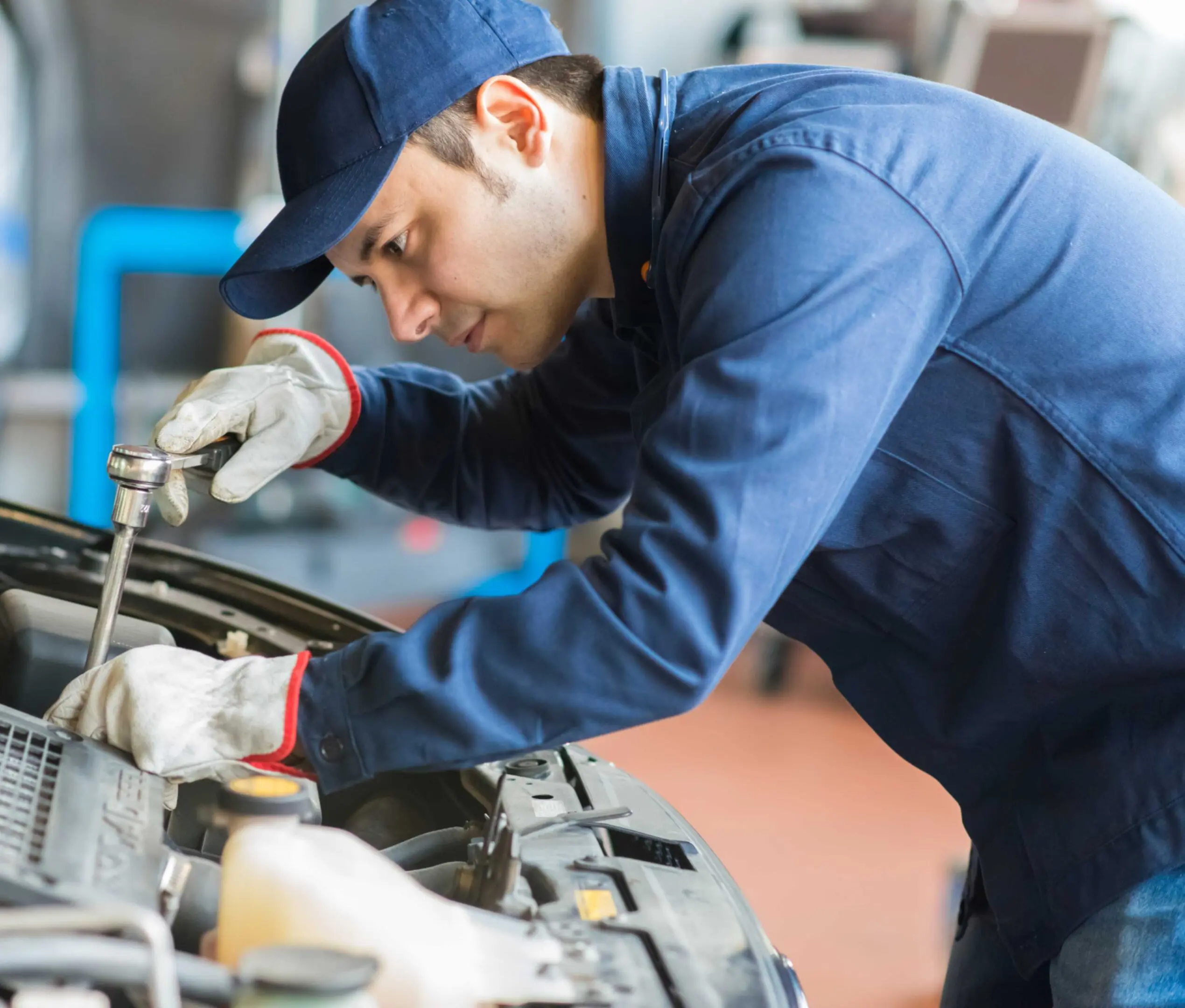jpeg-optimizer_GettyImages-472105032 Mechanic working under car hood.
