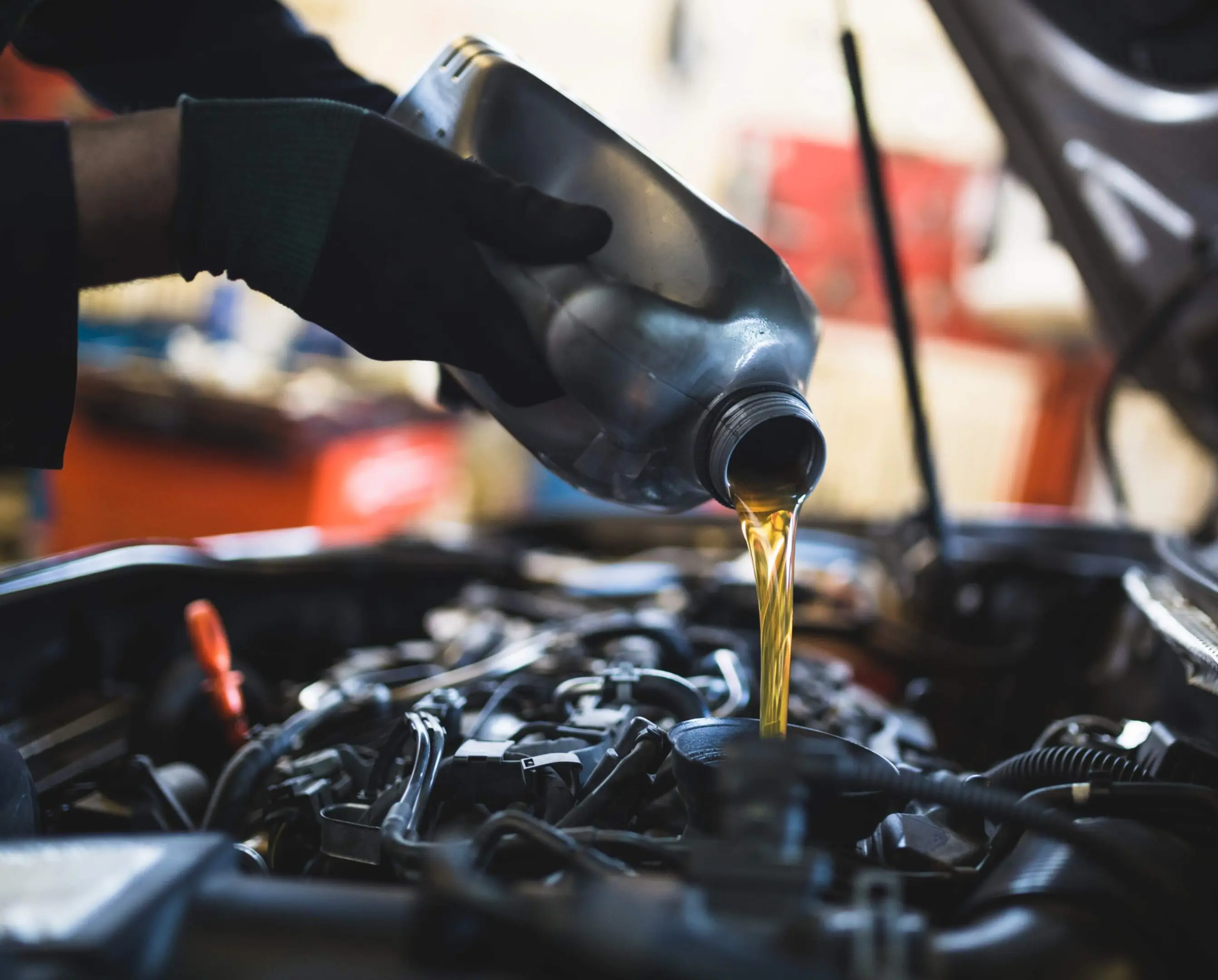 jpeg-optimizer_GettyImages-652660470 Pouring oil into a car engine.